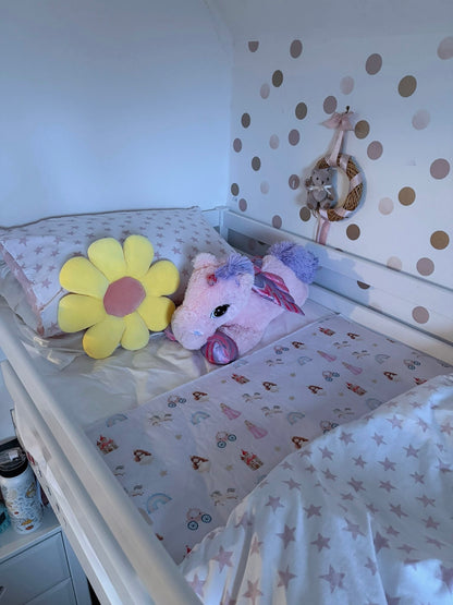 Single Bed with a unicorn plush toy and yellow flower decoration against a polka dot wall with a Quiet Kingdom Mattress Bed Sheet Protector